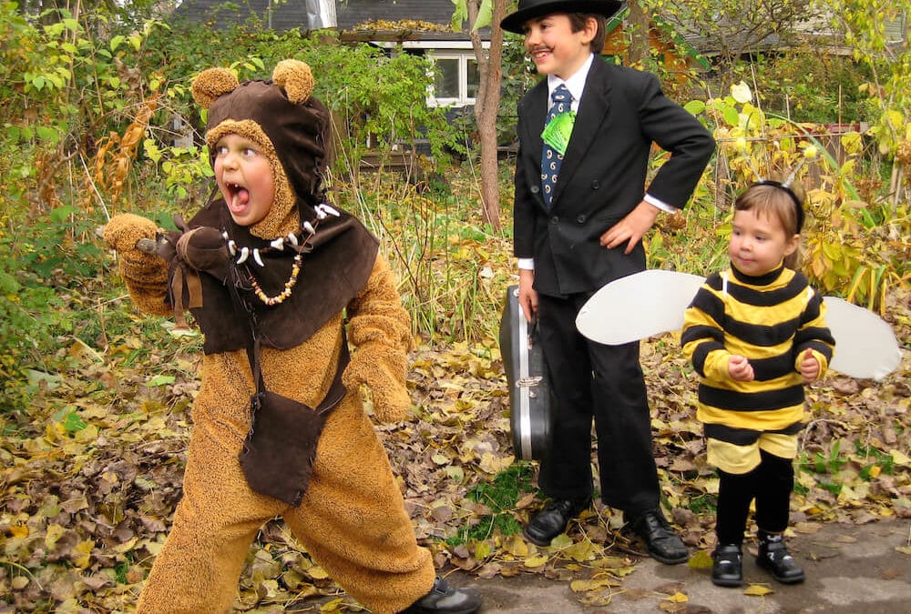 Children Dressed Up In Halloween Costumes, As a Bee and a Bear, and a Leprecon 